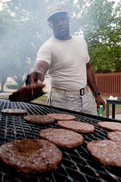 U.S. Air Force Staff Sgt. Michael Chapman, a food services specialist with the 23rd Force Support Squadron (FSS), flips burgers during a 23rd FSS block party at Moody Air Force Base, Ga., Aug. 30, 2011. Chapman and fellow Georgia Pines Dining Facility employees hosted the block party for all personnel on base. (U.S. Air Force photo by Staff Sgt. Joshua J. Garcia/Released)