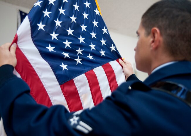 Airman 1st Class Jason Whipps practices Posting the Colors prior to performing at a retirement ceremony at Joint Base Charleston Aug. 26. Whipps is from the 437th Maintenance Squadron and is an avionics journeyman. (U.S. Air Force photo/Staff Sgt. Katie Gieratz)
