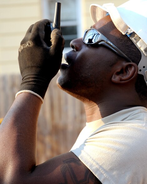Staff Sgt. Lakendrick Fisher, 85th Engineering and Installation Squadron team chief, Keesler Air Force Base, Miss., communicates with his teammates at the top of a 149-foot tower on Barksdale AFB, La., Aug. 31. Fisher and the other Airmen are on temporary duty here from Keesler to assist the 2nd Communications Squadron in the construction of the Barksdale Command Post tower. (U.S. Air Force photo/Senior Airman Amber Ashcraft) (RELEASED)