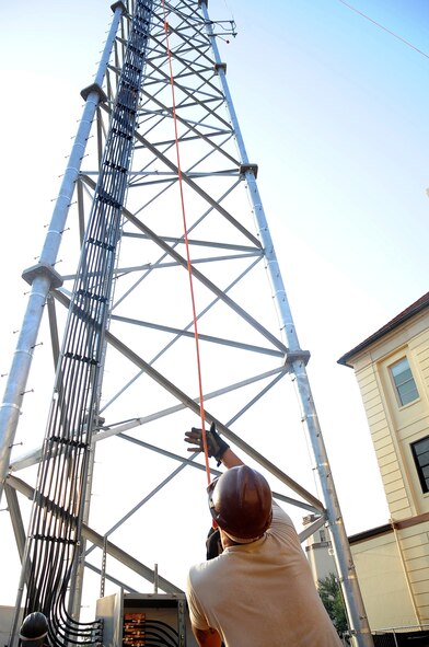 Senior Airman Nathan Williams, 85th Engineering and Installation Squadron technician, Keesler Air Force Base, Miss., tightens a safety rope attached to the top of a tower on Barksdale AFB, La., Aug. 31. Williams, along with several other Airmen, is on temporary duty here from Keesler to assist the 2nd Communications Squadron in the construction of the Command Post tower. (U.S. Air Force photo/Senior Airman Amber Ashcraft) (RELEASED)
