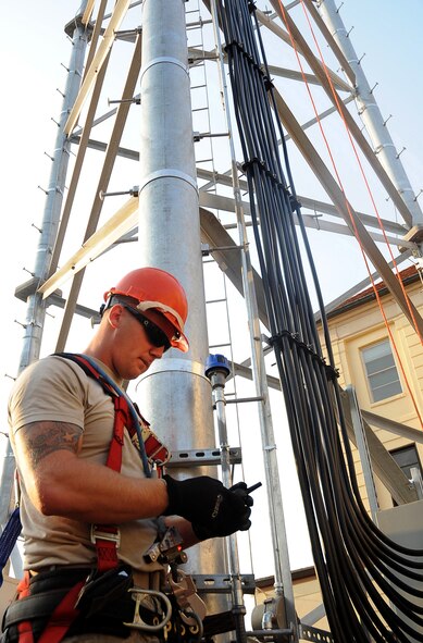 Senior Airman Travis Crowell, 85th Engineering and Installation Squadron technician, Keesler Air Force Base, Miss., preps his radio before his ascent up the Command Post tower on Barksdale AFB, La., Aug. 31. Crowell and several other Airmen are on temporary duty here from Keesler to assist the 2nd Communication Squadron in the construction of the Command Post tower. (U.S. Air Force photo/Senior Airman Amber Ashcraft) (RELEASED)