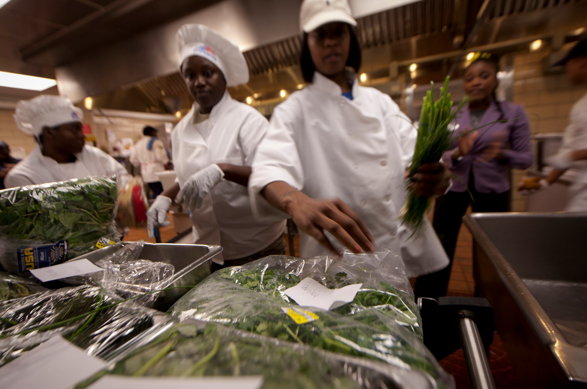 Members participating in the Iron Chef Competition scramble to collect ingredients for their appetizers and main dishes at Moody Air Force Base, Ga., Aug. 30, 2011. The competition was hosted by the 23rd Force Support Squadron and had four two-person teams go head-to-head for the title of Iron Chef. (U.S. Air Force photo by Airman 1st Class Joshua Green/Released) 
