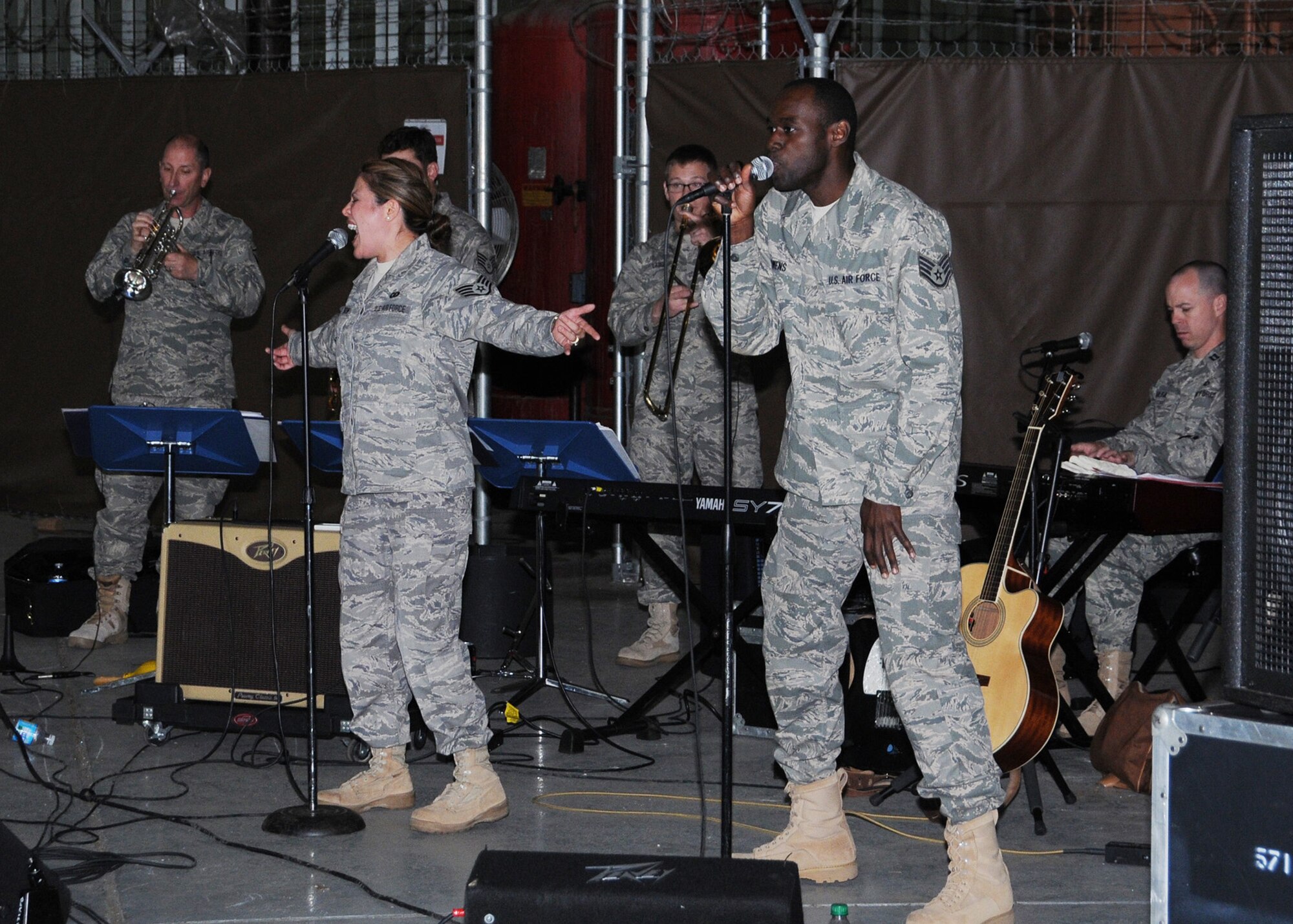 Vocalists SSgts Angie Johnson and Brian Owens perform with Sidewinder at a recent morale call prior to the group deploying to Southwest Asia for 45 days. The rock ensemble is an element of the 571st Air Force Band "Air National Guard Band of the Central States" . The band is based at the 131st Bomb Wing, Lambert -Saint Louis. Sidewinder returned from deployment Sept 3. (Photo by Mary-Dale Amison)