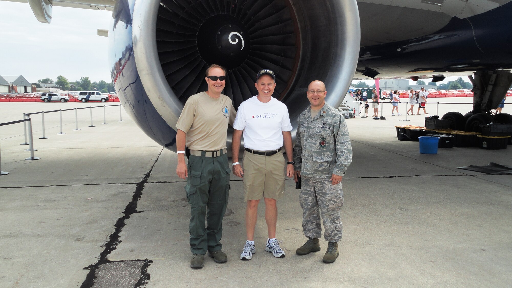 Doug Mann, regional director of maintenance for Delta Air Lines, stands between Major Todd Rupright, right, commander of the 127th Civil Engineering Squadron, and Senior Airman Ryan Dunlap, left, a member of the 127th CES. Dunlap, who works at Delta as an aircraft maintainer in his civilian job, was able to assist a Delta crew that was displaying a Delta airliner at the 2011 Selfridge Air Show, Aug. 21, 2011, at Selfridge Air National Guard Base, Mich. (USAF photo by SSgt. Bradley Moehlig) 