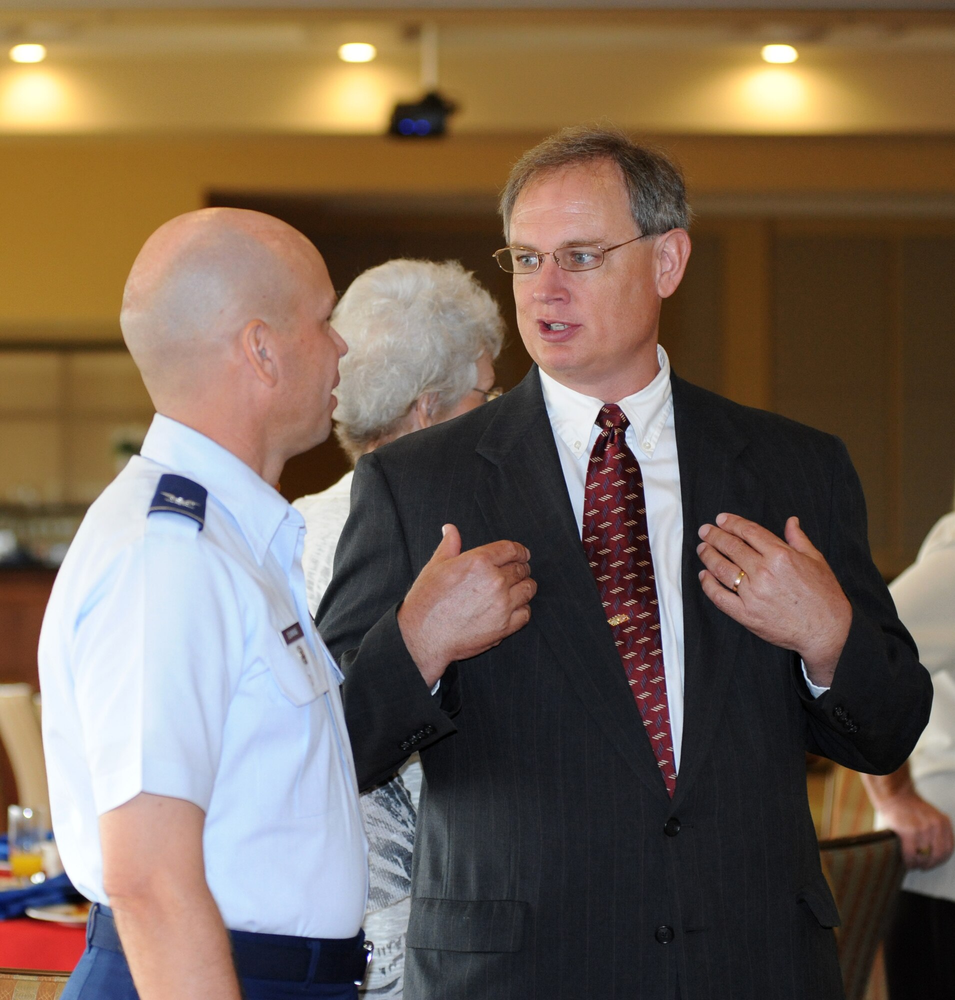 Col. Glen Downing, 81st Training Wing vice commander, chats with Arthur McMillan, superintendent of the Biloxi Public School System, during the Biloxi Chamber of Commerce Morning Call, Aug. 25.  Keesler sponsored the event at the Bay Breeze Event Center as part of the base's 70th birthday celebration.  (U.S. Air Force photo by Kemberly Groue)