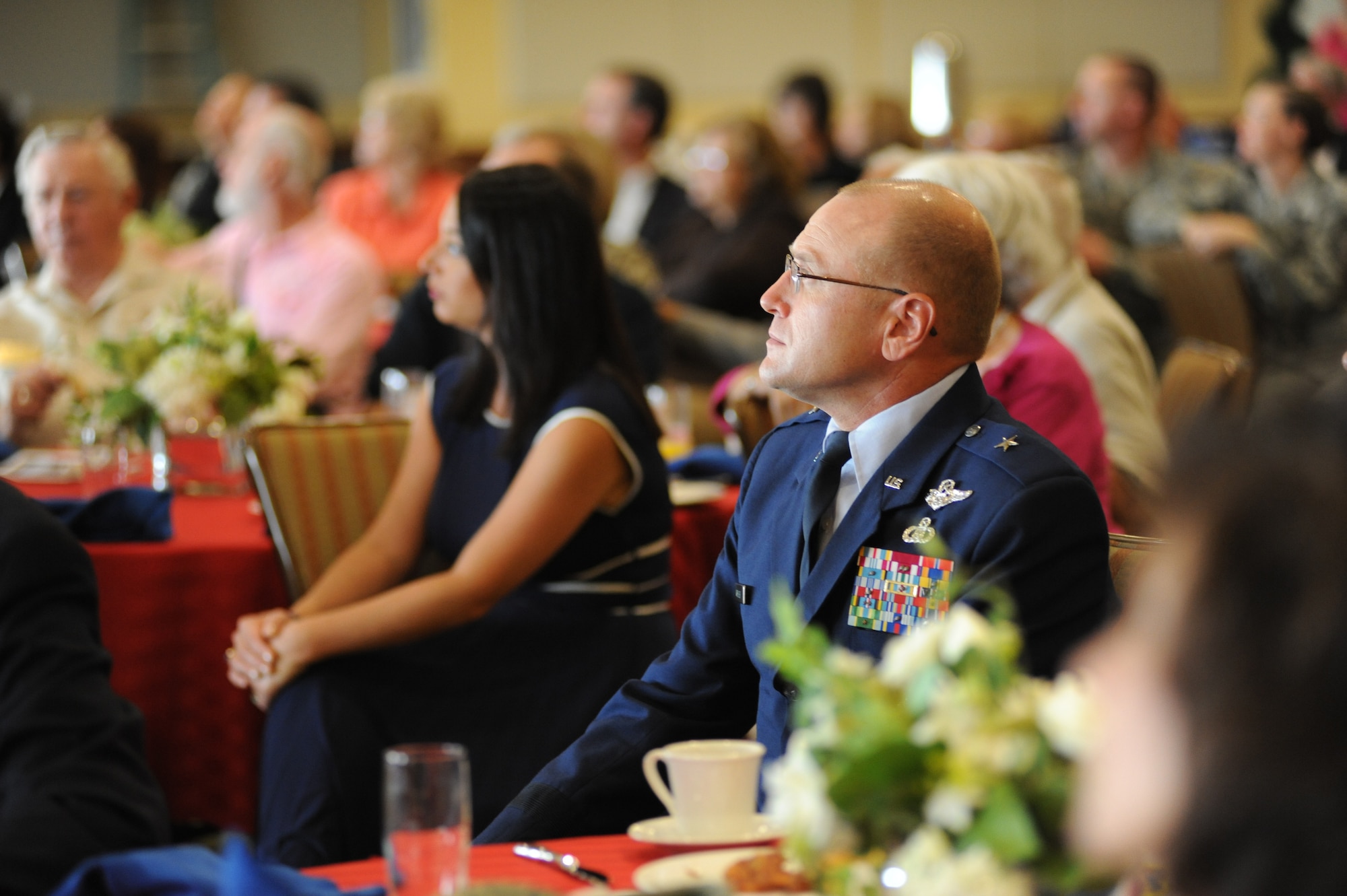Brig. Gen. Andrew Mueller, 81st Training Wing commander, and guests watch a video about the Mississippi Special Olympics Summer Games hosted by Keesler last May during the Biloxi Chamber of Commerce Morning Call, Aug. 25.  Keesler sponsored the event at the Bay Breeze Event Center as part of the base's 70th birthday celebration.  (U.S. Air Force photo by Kemberly Groue)