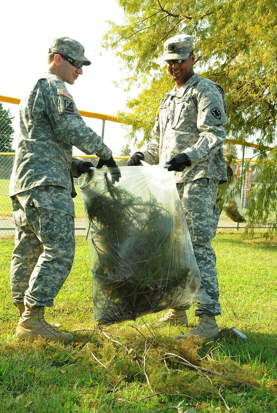 U.S. Army Spc. Brett Whittenburg and Pfc. Ross Spears, 579 Transportation Company specialist, collect branches left from Hurricane Irene at Fort Eustis, Va., Aug. 29, 2011. The hurricane caused widespread flooding, downed trees, and power outages across Virginia and North Carolina. (U.S. Air Force photo by Staff Sgt. Antoinette Gibson/Released)