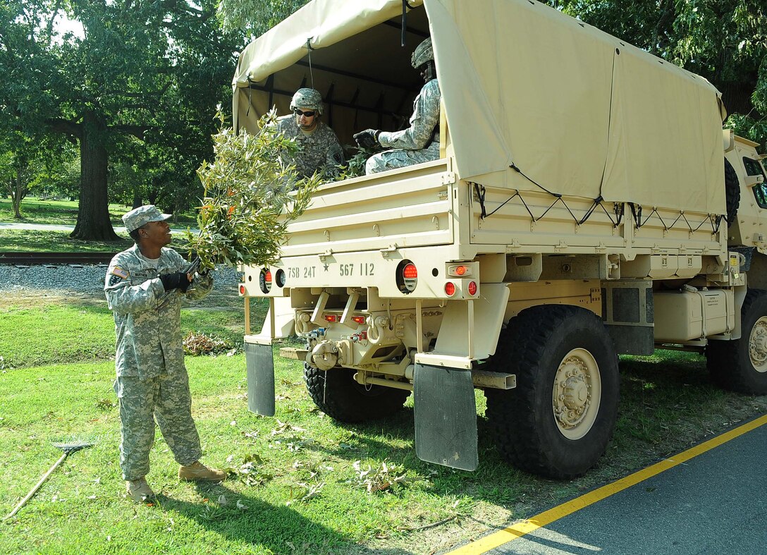 U.S. Army Staff Sgt. Alger Warthen, 7th Sustainment Brigade inland cargo transfer specialist, cleans debris left by Hurricane Irene at Fort Eustis, Va., Aug. 29, 2011. Hurricane detail teams have been working on base recovery since the passing of the storm on Sunday. (U.S. Air Force photo by Staff Sgt. Antoinette Gibson/Released)