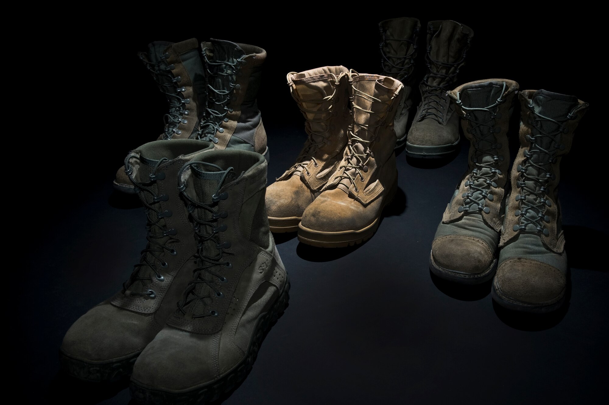 A variety of military boots are set out Aug. 30, 2011, at Nellis Air Force Base, Nev. The new Air Force Instruction 36-2903, which was revised July 13, 2011, states Airmen are not allowed to wear tan boots effective 1 November 2011, tan boots will not be worn with the ABU unless authorized by the Theater commander for wear only in theater. The tan boot may be worn with the desert flight duty uniform indefinitely. (U.S. Air Force photo by Airman 1st Class Daniel Hughes/Released)

