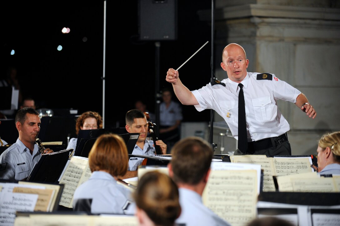 International guest conductor from Denmark, Captain Martin Åkerwall, conducts the U.S. Air Force Concert Band at the U.S. Capitol on August 16. Captain Åkerwall is the conductor of the Band of the Royal Danish Life Guards. (U.S. Air Force photo by Staff Sgt. Raymond Mills)
