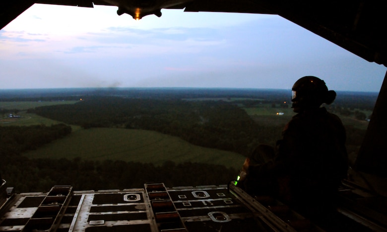 Tech. Sgt. Patrick Taylor, a loadmaster for 711th Special Operations Squadron, looks out of the cargo bay of the MC-130E Talon I during a training flight out of Duke Field, Fla. Loadmasters are responsible for preparing the cargo for air drops and manually releasing loads, if not on automatic systems. The 711th SOS, part of the 919th Special Operations Wing, conducts flight training missions five days a week to maintain currency on all of their readiness requirements. (U.S. Air Force photo/Tech. Sgt. Cheryl Foster)