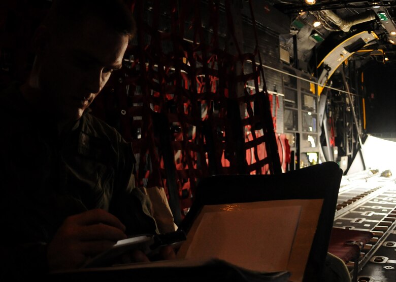 Tech. Sgt. Patrick Taylor, a loadmaster for 711th Special Operations Squadron, calculates weight and balance for the MC-130E Talon I before a training flight on Duke Field, Fla. Loadmasters are responsible for ensuring the aircraft’s cargo is loaded and restrained properly. The 711th SOS, part of the 919th Special Operations Wing, conducts flight training missions five days a week to maintain currency on all of their readiness requirements. (U.S. Air Force photo/Tech. Sgt. Cheryl Foster)