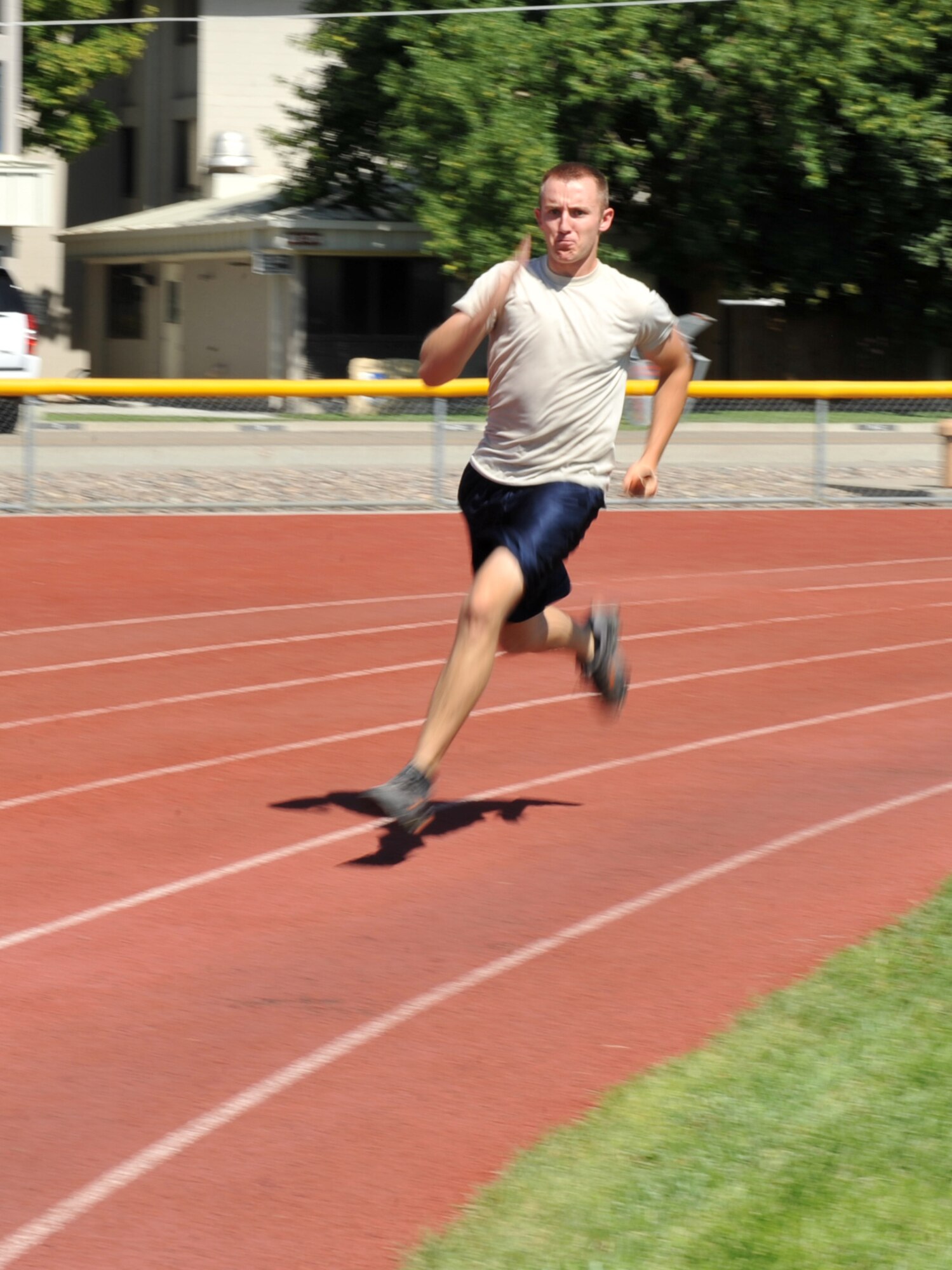 MOUNTAIN HOME AIR FORCE BASE, Idaho – Airman 1st Class Christopher Green, 366th Force Support Squadron, hands off a baton to his teammate during the 4x100-meter dash Aug. 25 here. Each team consisted of four members who each ran 100-meters to the next teammate who they passed the baton to. (U.S. Air Force photo by Airman 1st Class Heather Hayward)