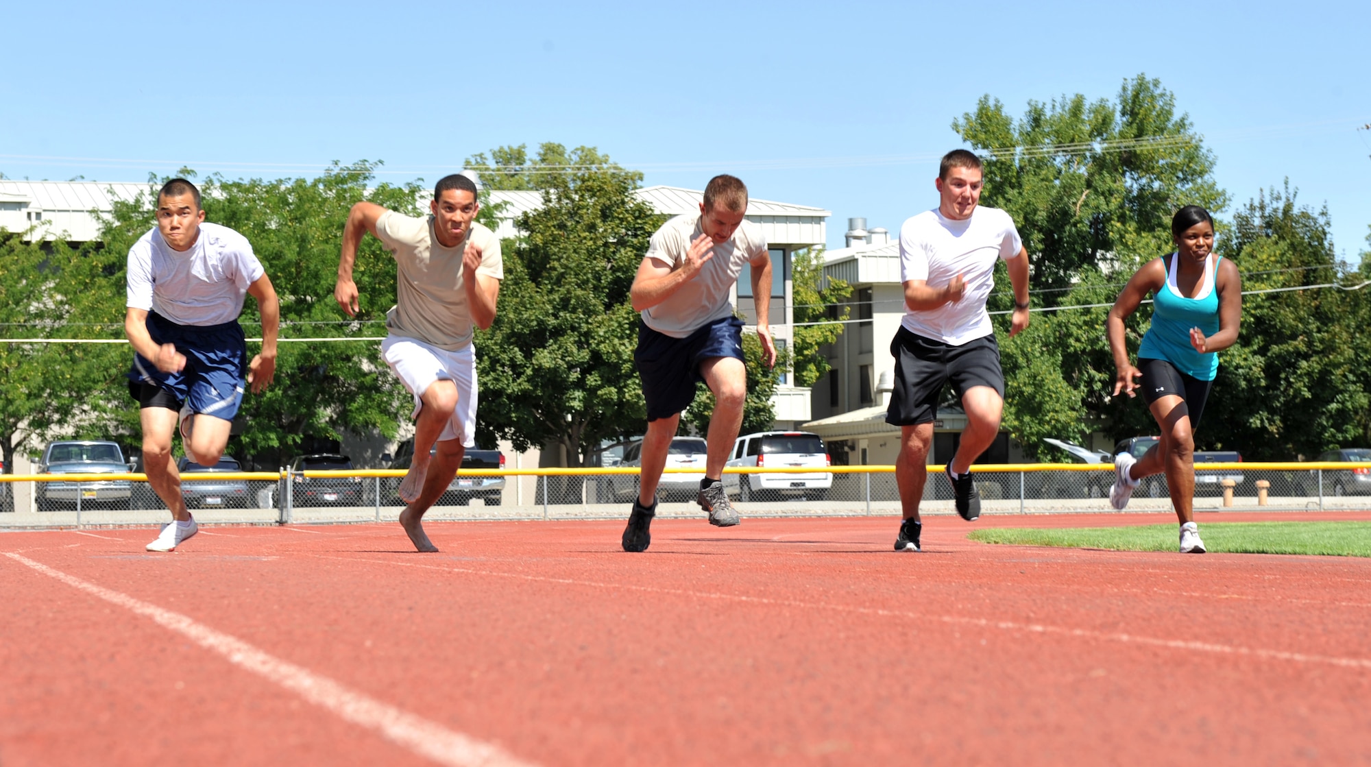 MOUNTAIN HOME AIR FORCE BASE, Idaho – Base personnel participate in the 100-meter dash during the Gunfighter Relays Aug. 25 here. A total of 19 members participated in the events, such as the 100-meter dash, 200-meter dash, 400-meter dash, 1600-meter dash, and the 4x100-meter dash. (U.S. Air Force photo by Airman 1st Class Heather Hayward)