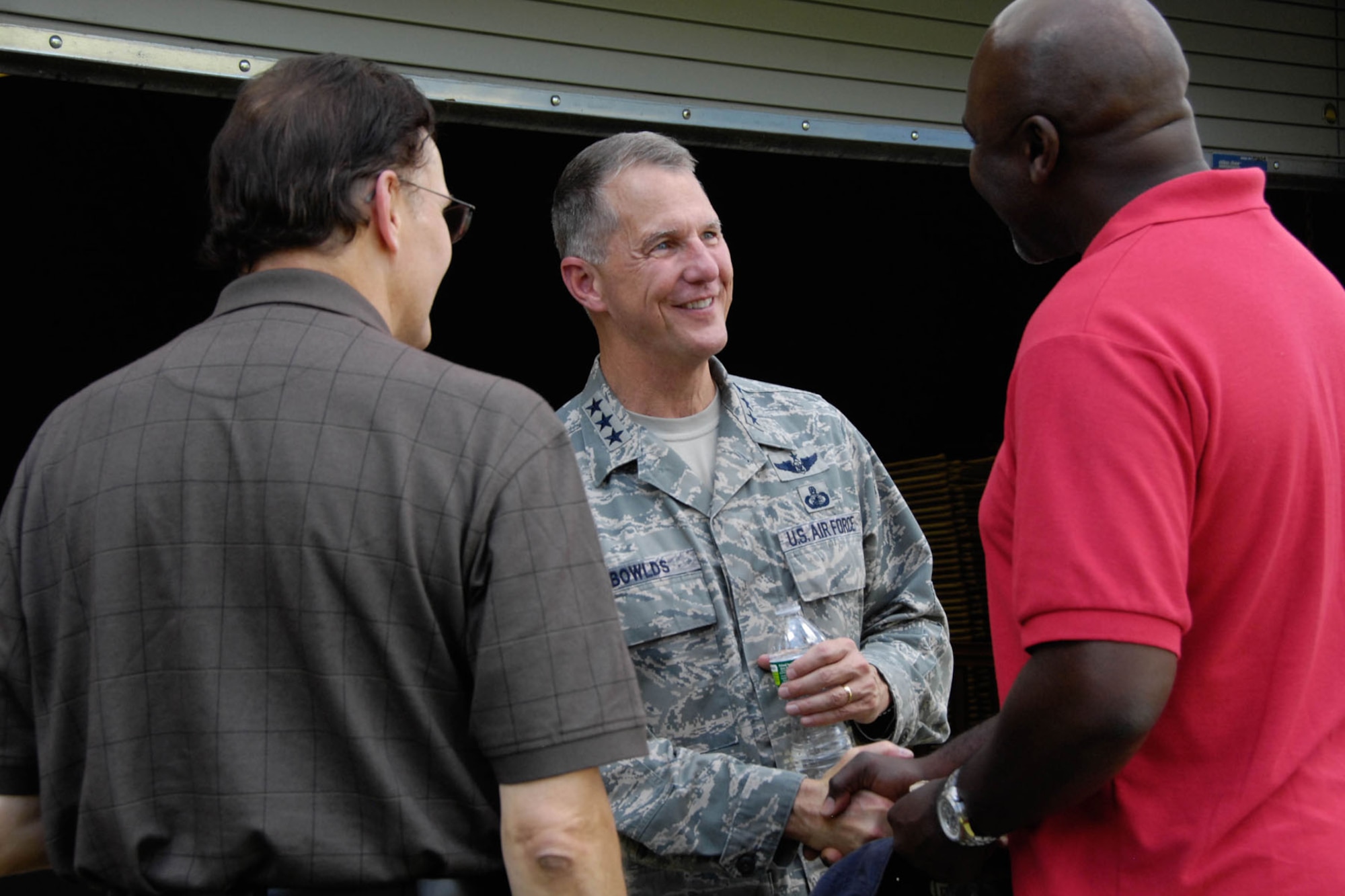 HANSCOM AIR FORCE BASE, Mass. - Lt. Gen. Ted Bowlds, Electronic Systems Center commander, greets Fred Kondrat (left) and Sylvester Ryan during an installation picnic Aug. 26. General Bowlds is preparing to retire and a farewell event for him followed the picnic. His retirement ceremony will be on Sept. 1, following the ESC change of command. (U.S. Air Force photo by Linda LaBonte Britt)