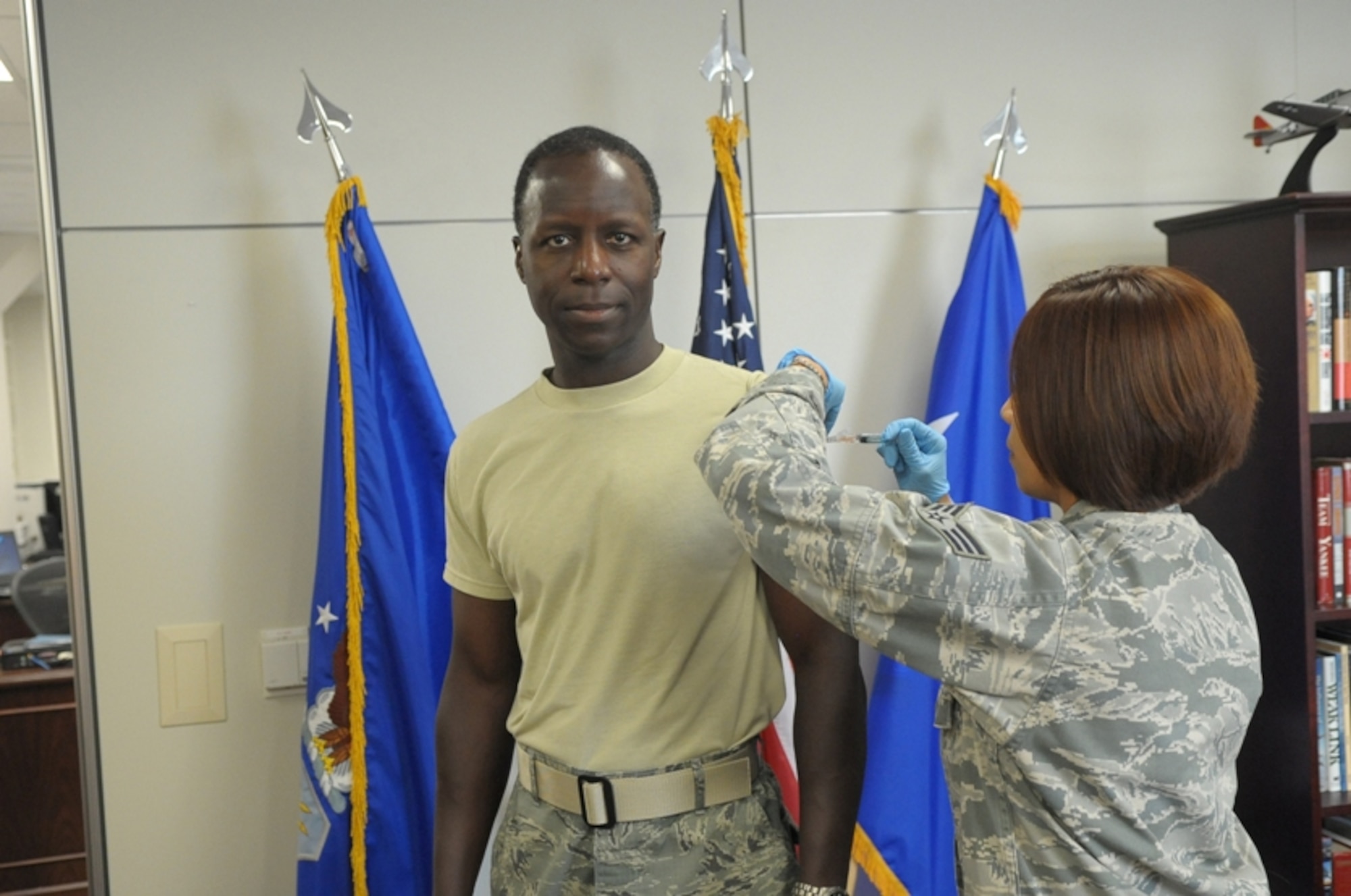 ANNUAL FLU SHOTS BEGIN -- Air Education and Training Command Commander, Gen. Edward A. Rice Jr., received his annual influenza immunization from Senior Airman Jacqueline N. Camposgarcia, 359th Medical Operations Squadron Immunization Clinic journeyman, at Randolph Air Force Base, Tuesday (Aug. 30). Immunization Clinic staffs around the command are gearing up to provide nasal spray and injections beginning with active duty personnel at the Clinic and designated locations around the base. Check with your orderly room or the Immunization Clinic for a date and location to fit your schedule. (U.S. Air Force Photo/Joel Martinez)