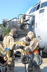 Team members participating in the 402nd EDMX exercise go back to work repairing battle damage to an aircraft after a simulated attack on their base. U. S. Air Force photo by Sue Sapp