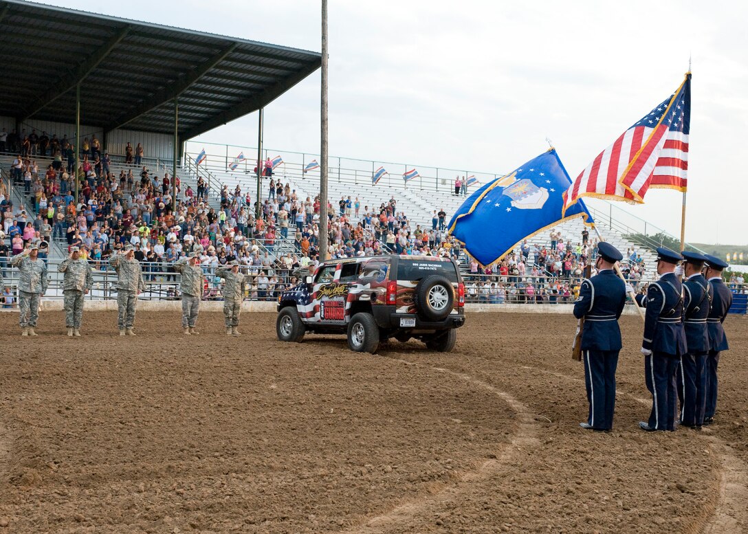Members of the Ellsworth Air Force Base Honor Guard present the colors during the opening ceremony of the Range Days Rodeo at the Central States Fairgrounds in Rapid City, S.D., Aug. 25, 2011. Five Ellsworth Airmen and five South Dakota National Guardsmen were recognized for their service during the event that culminated with a B-1B flyover. (U.S. Air Force photo/Airman Alystria Maurer/Released)