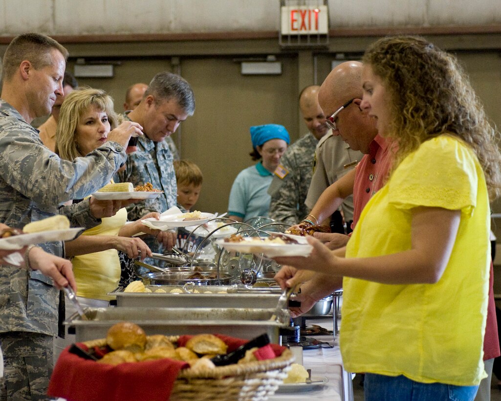 Ellsworth Airmen, South Dakota National Guard soldiers and their families and friends enjoy the food and festivities during the 25th Annual Pig Roast & Military Appreciation Event hosted by the Rapid City Area Chamber of Commerce Military Affairs Committee at the Central States Fairgrounds in Rapid City, S.D., Aug. 25, 2011. Five Ellsworth Airmen and five guardsmen were recognized for their service during the event. (U.S. Air Force photo/Airman Alystria Maurer/Released)