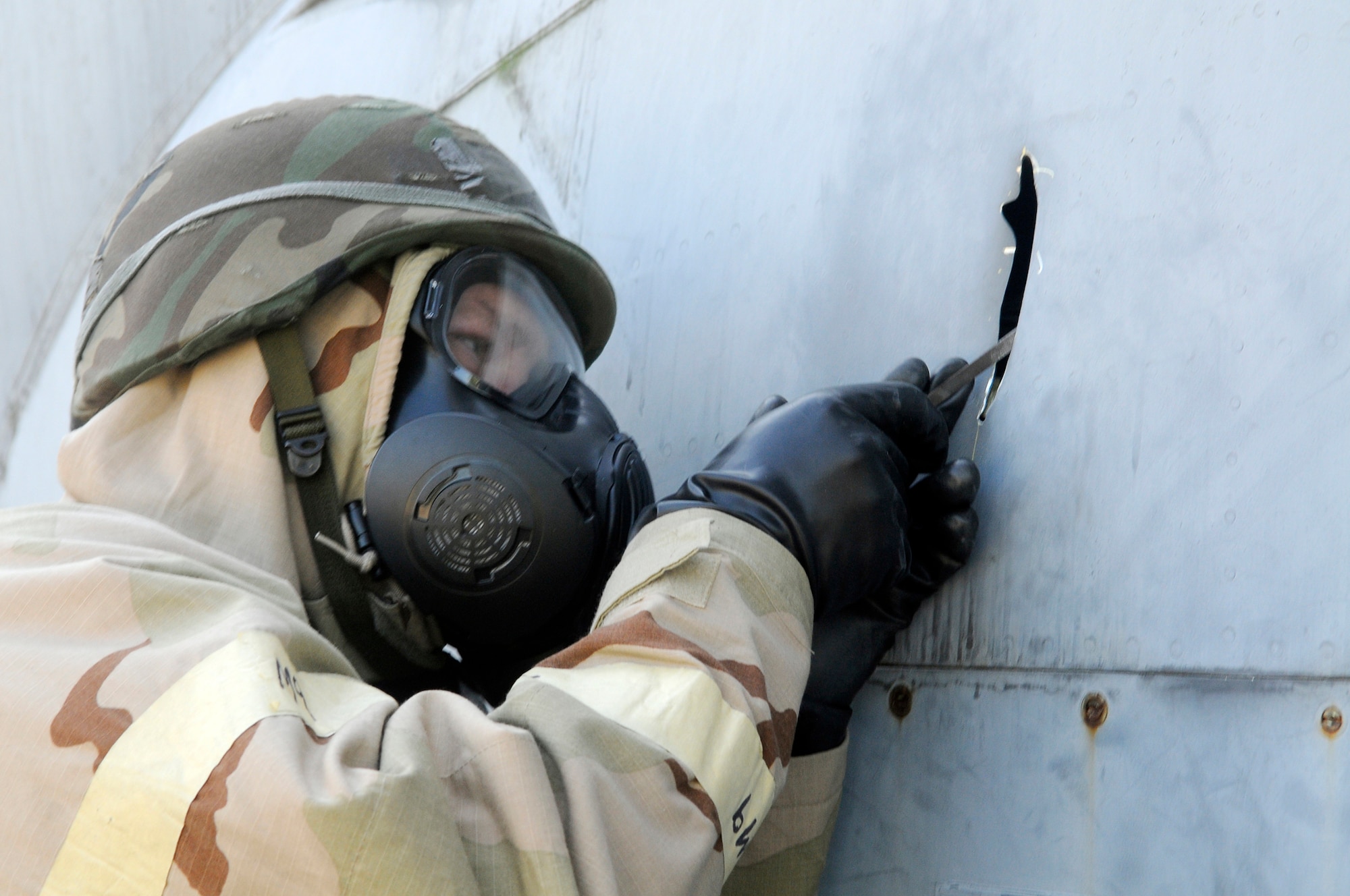TSgt. Kevin Riegel prepares an area of battle damage to an aircraft so a repair can be made during the 402nd EDMX exercise. U. S. Air Force photo by Sue Sapp