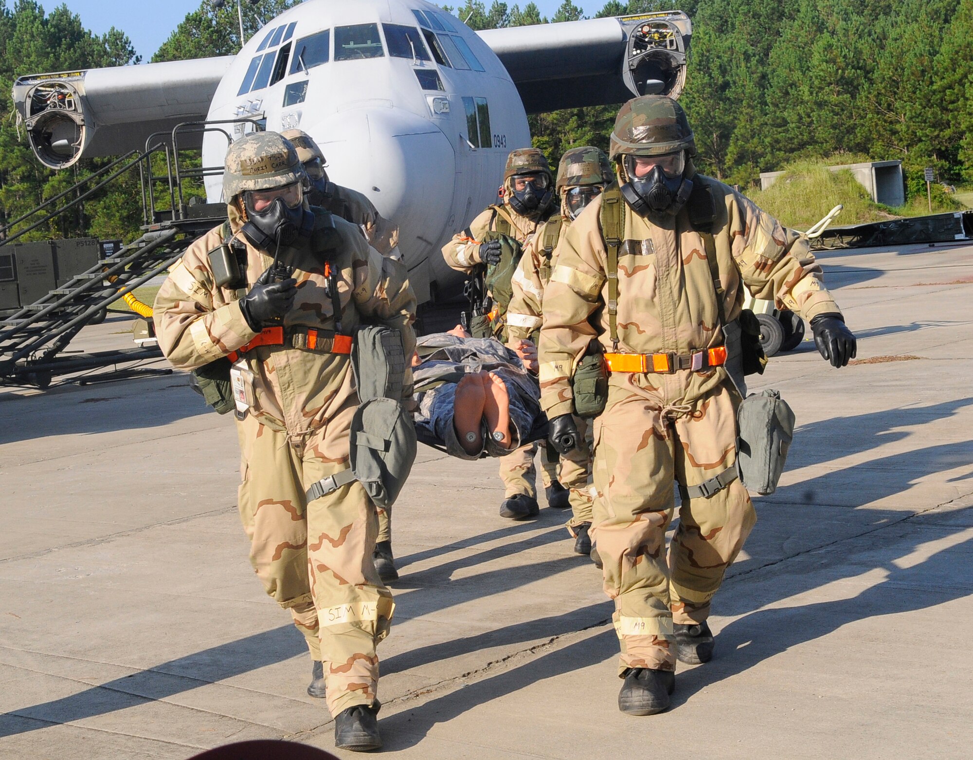 Team members participating in the 402nd EDMX exercise recover a casualty after a simulated attack on their base. U. S. Air Force photo by Sue Sapp