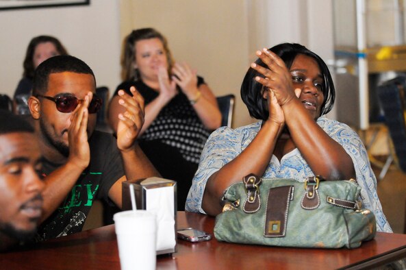 Audience members clap for a contestant's performance. U. S. Air Force photo by Sue Sapp
