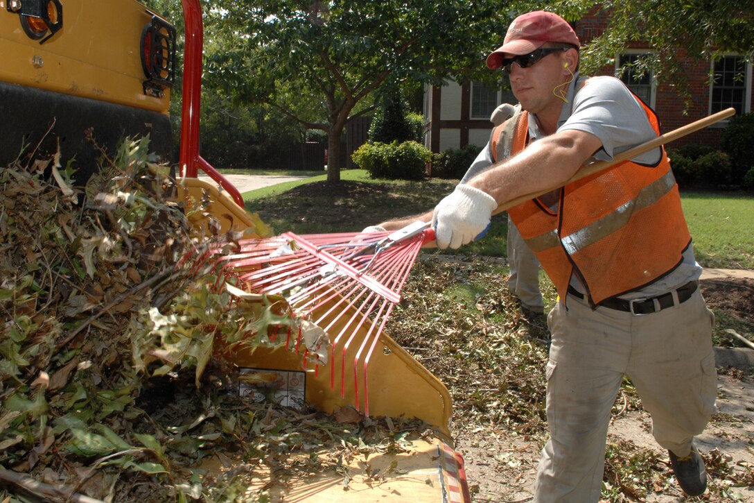 Matt Lamberski, a contractor from a local landscaping company, removes fallen tree branches from base housing caused by Hurricane Irene Aug. 30, 2011 at Langley Air Force Base, Va. The landscapers were hired to clean up debris left as a result of the category one hurricane. (United States Air Force photo by Staff Sgt Jeff Nevison/RELEASED)