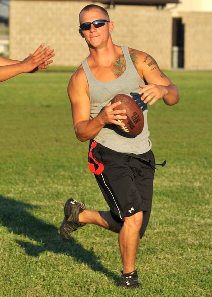 Steven Peaper, quarterback for the 436th Civil Engineer Squadron, runs a bootleg during a flag football scrimmage with the 436th Logistics Readiness Squadron at Dover Air Force Base, Del., Aug. 30, 2011. Both teams held a scrimmage since games were cancelled due to Hurricane Irene. (U.S. Air Force photo by Tech. Sgt. Chuck Walker)