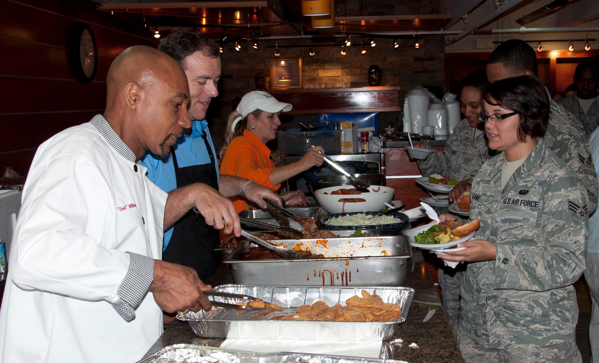 Veteran and TV personality Montel Williams serves lunch to Airmen in the USO Lounge of the Charles C. Carson Center for Mortuary Affairs Aug. 25, 2011. Williams and his team of friends and family hosted the luncheon to show their support to those who care for the fallen and their families. (U.S. Air Force photo/Tech. Sgt. Marvin Moore)