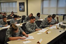 Airmen participate in the Alive at 25 course at Seymour Johnson Air Force base Aug. 24, 2011. Airmen read aloud, answered questions and interacted with the instructors to get a better understanding of safe driving habits. The Alive at 25 handbook points out driving statistics, hazards Airmen encounter everyday while driving and asks them what they think is the most distracting thing while driving. These Airmen are the first students to go through this course here. (U.S. Air Force photo by Airman 1st Class Mariah Tolbert/Released)