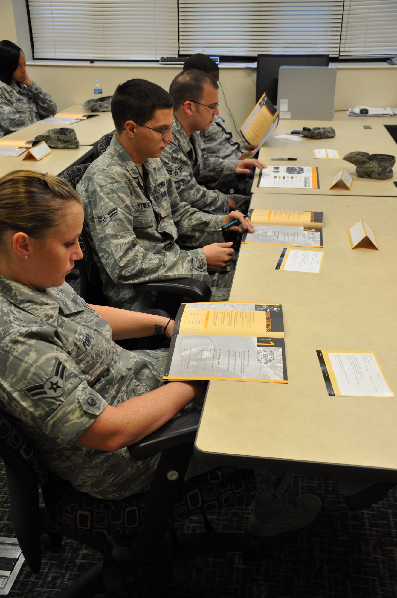 Airmen participate in Alive at 25 course at Seymour Johnson Air Force base Aug. 24, 2011. Airmen read along in a defensive driving course booklet created to promote safe driving for younger Airmen. The course began as a replacement for the 3B defensive driving course offered to new Airmen. Alive at 25 is a defensive driving course offered to people under the age of 25.  (U.S. Air Force photo by Airman 1st Class Mariah Tolbert/Released)