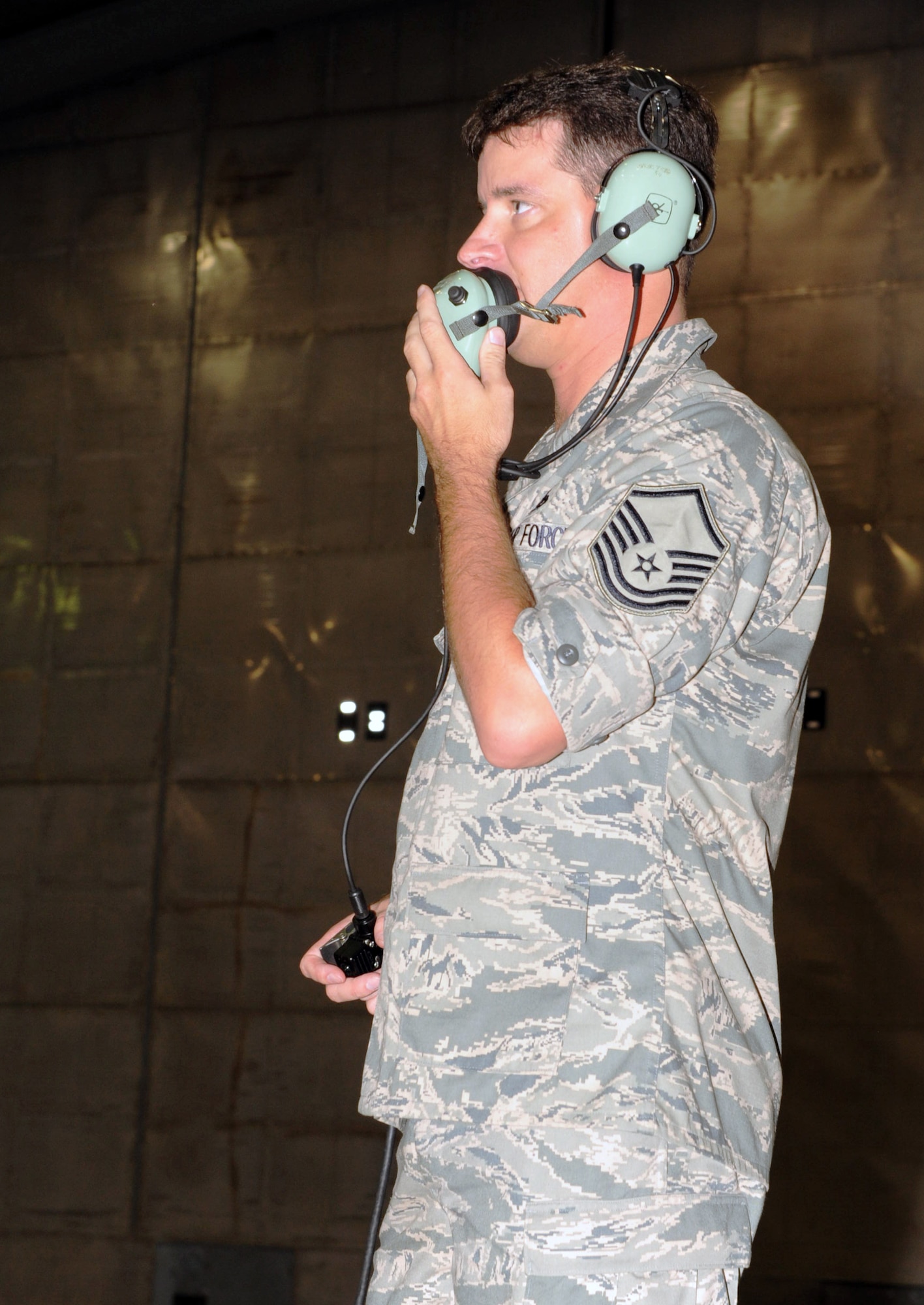 U.S. Air Force Master Sgt. Joshua Varney, 20th Component Maintenance Squadron engine test facility section chief, communicates with the engine operators before starting up an engine at Shaw Air Force Base, S.C. Aug. 30, 2011. The F110-General Electric-129 F-16 Fighting Falcon engine is tested at the hush house. The hush house is a term used for an enclosed, noise suppressed test facility for installed or uninstalled engines under a variety of engine operating conditions. (U.S. Air Force photo/Airman 1st Class Tabatha L. Duarte)(Released)