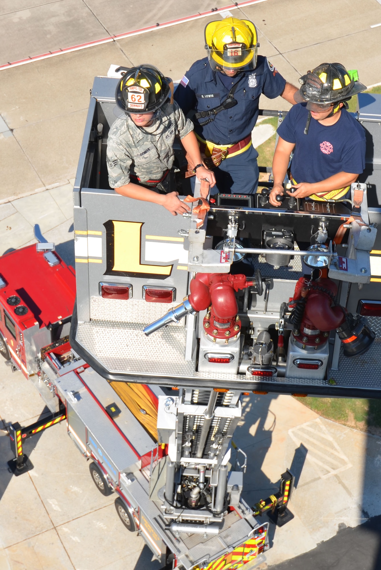 Fire teams conduct aerial ladder placement training here Aug. 23-24. (U.S. Air Force Photo/Don Peek)
