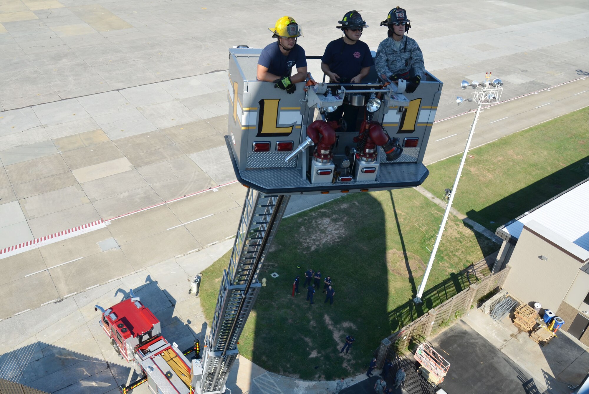 Firefighters from the Dobbins and Smyrna, Ga., Fire Departments make their way to the air traffic control tower cab during aerial ladder placement training conducted here Aug. 23-24. (U.S. Air Force Photo/Don Peek)