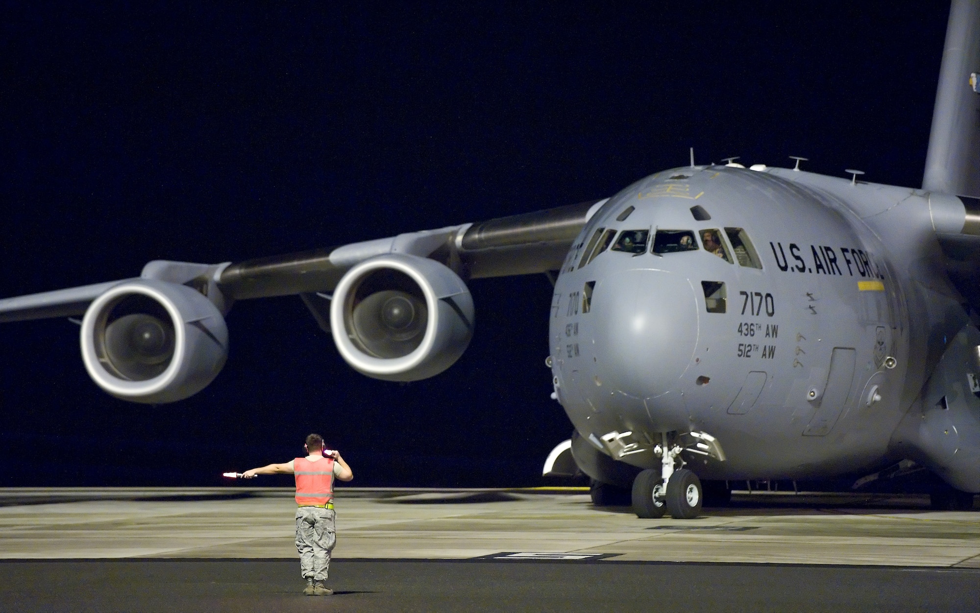 Aircraft maintenance personnel marshall out the last C-17 Globemaster III prior to the arrival of Hurricane Irene, on Aug. 26, 2011, at Dover Air Force Base, Del. (U.S. Air Force photo by Roland Balik)