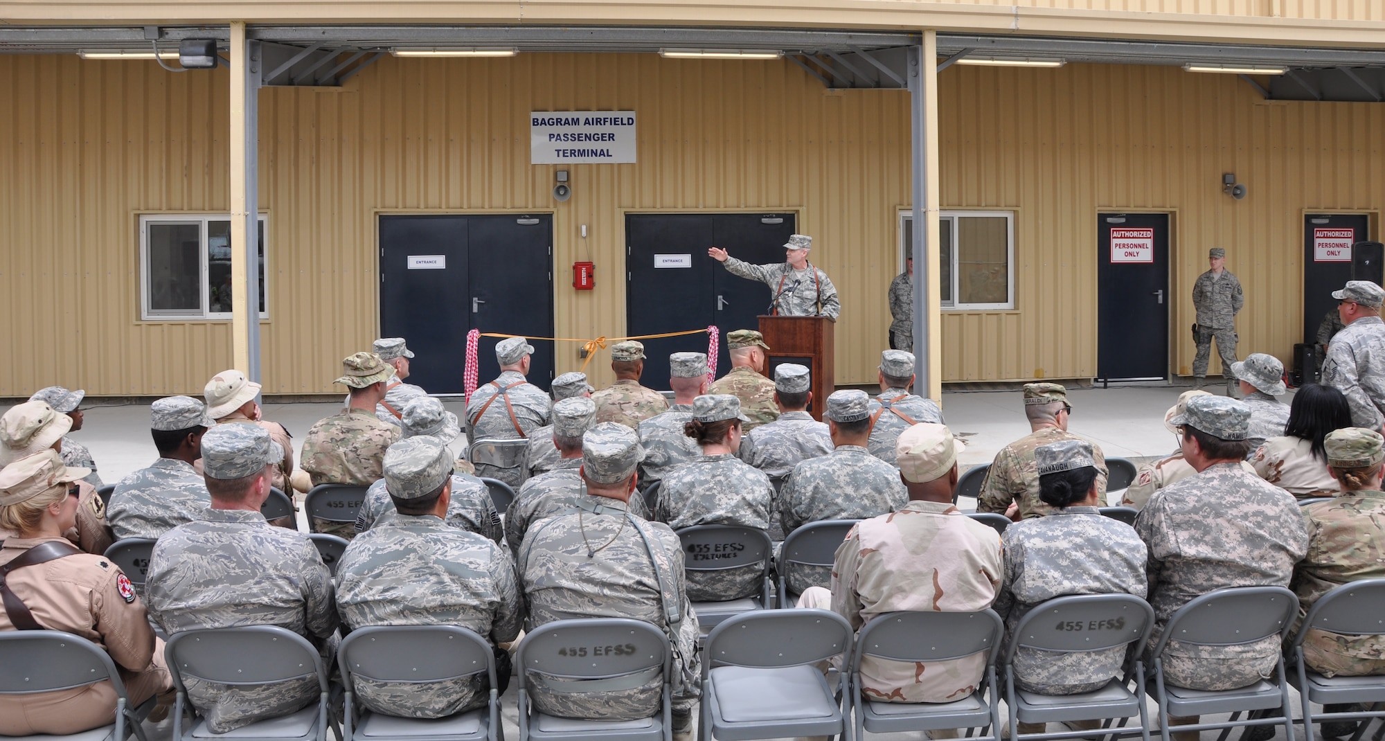BAGRAM AIRFIELD, Afghanistan -- Brig. Gen. Darryl Roberson, 455th Air Expeditionary Wing commander, addresses the crowd during the grand opening of a new 45,000-square foot passenger terminal here Aug. 31, 2011. The new terminal is six times the size of the old 7,500-square foot passenger terminal and will have a throughput of approximately 1,400 people per day. It also boasts room for 1,250 people, more than quadrupling the 250-person capacity of the old terminal. (U.S. Air Force photo/Staff Sgt. John Wright)