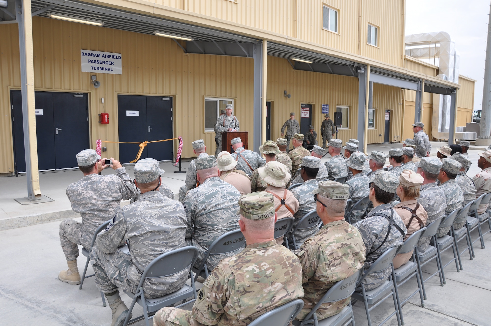 BAGRAM AIRFIELD, Afghanistan -- Brig. Gen. Darryl Roberson, 455th Air Expeditionary Wing commander, addresses the crowd during the grand opening of a new 45,000-square foot passenger terminal here Aug. 31, 2011. The new terminal is six times the size of the old 7,500-square foot passenger terminal and will have a throughput of approximately 1,400 people per day. It also boasts room for 1,250 people, more than quadrupling the 250-person capacity of the old terminal. (U.S. Air Force photo/Staff Sgt. John Wright)