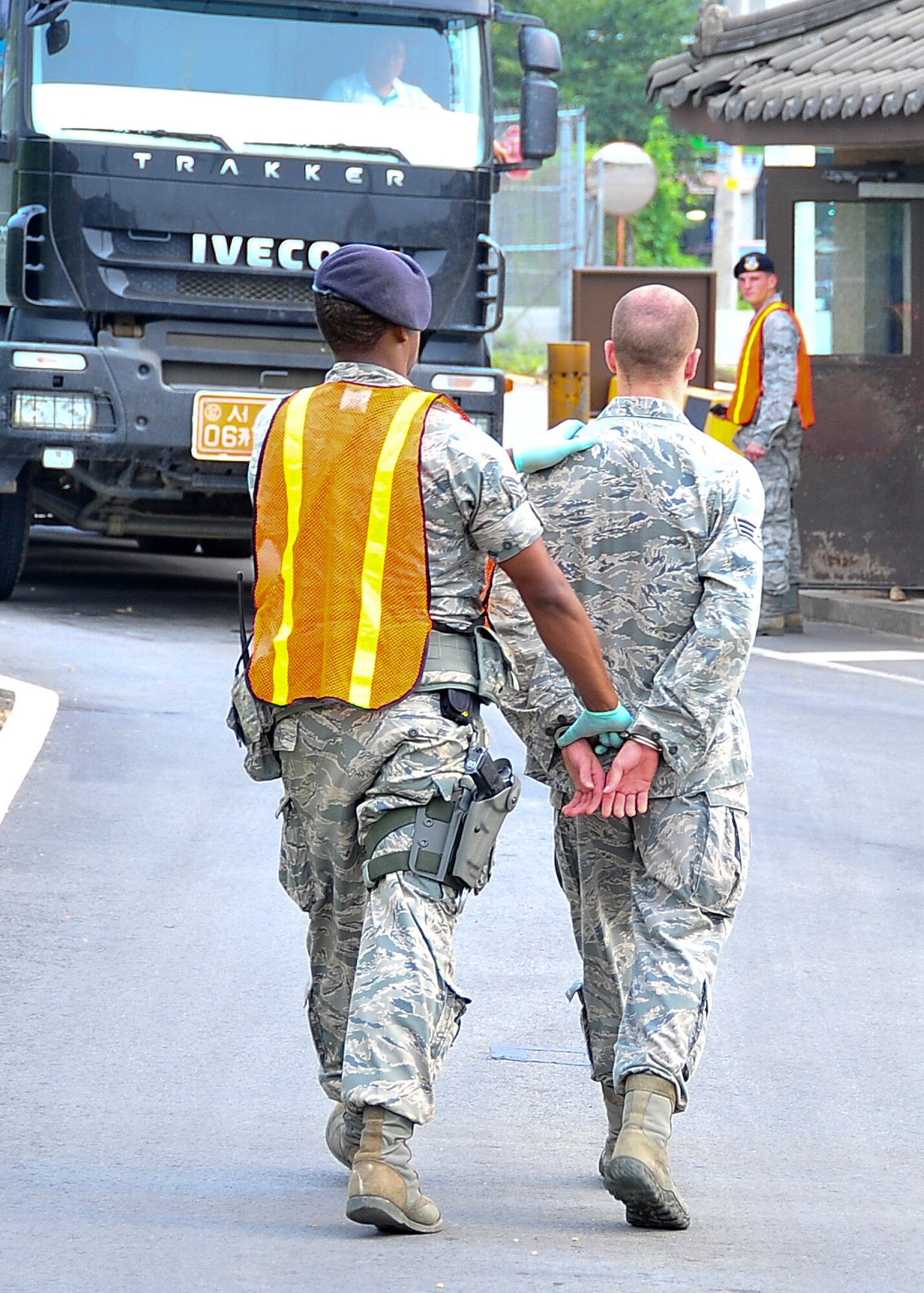 A member or the 51st Security Forces Squadron apprehends and individual after a search of his vehicle showed evidence of contraband Aug. 29, 2011 during exercise Beverly-Midnight 11-04. This portion of the exercise tests the Airmen’s ability to react in a hi-stress situation while still completing the mission. (U.S. Air Force photo/Senior Airman Adam Grant)  