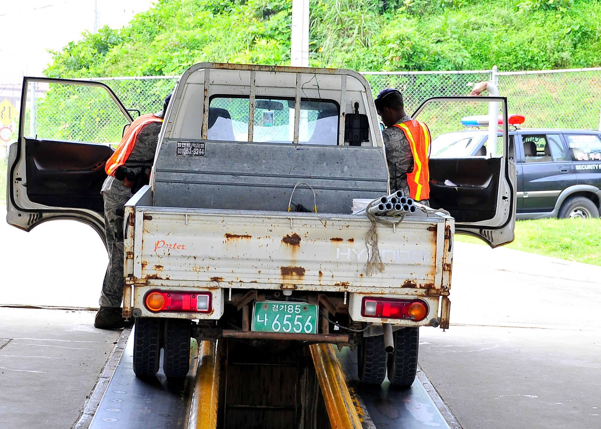 Airmen of the 51st Security Forces Squadron perform vehicle checks Aug. 29, 2011 during exercise Beverly-Midnight 11-04. The Airmen are checking for prohibited items that are not allowed on Osan Air Base. (U.S. Air Force photo/Senior Airman Adam Grant)