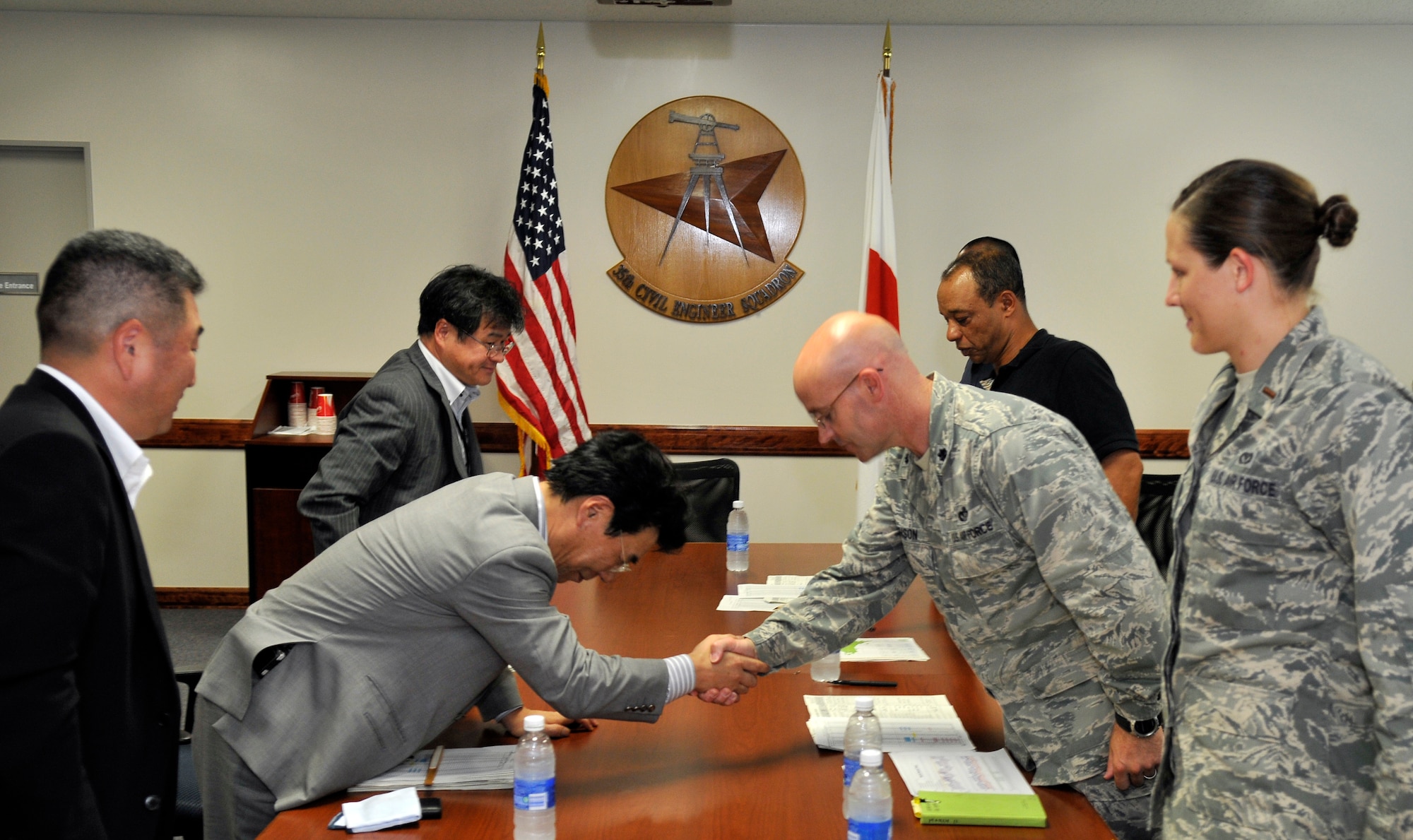 MISAWA AIR BASE, Japan – Mr. Tadashi Ozawa, Tohoku Electric Company Aomori Branch vice manager and Lt. Col. Dwayne Robison, 35th Civil Engineer Squadron commander, shake hands and bow to each other at the conclusion of a meeting Aug. 31 in the 35 CES conference room here. Tohoku Electric Company meets with base officials to praise Misawa’s energy conservation efforts and map out the way ahead for further conservation efforts. (U.S. Air Force photo/Tech. Sgt. Phillip Butterfield)
