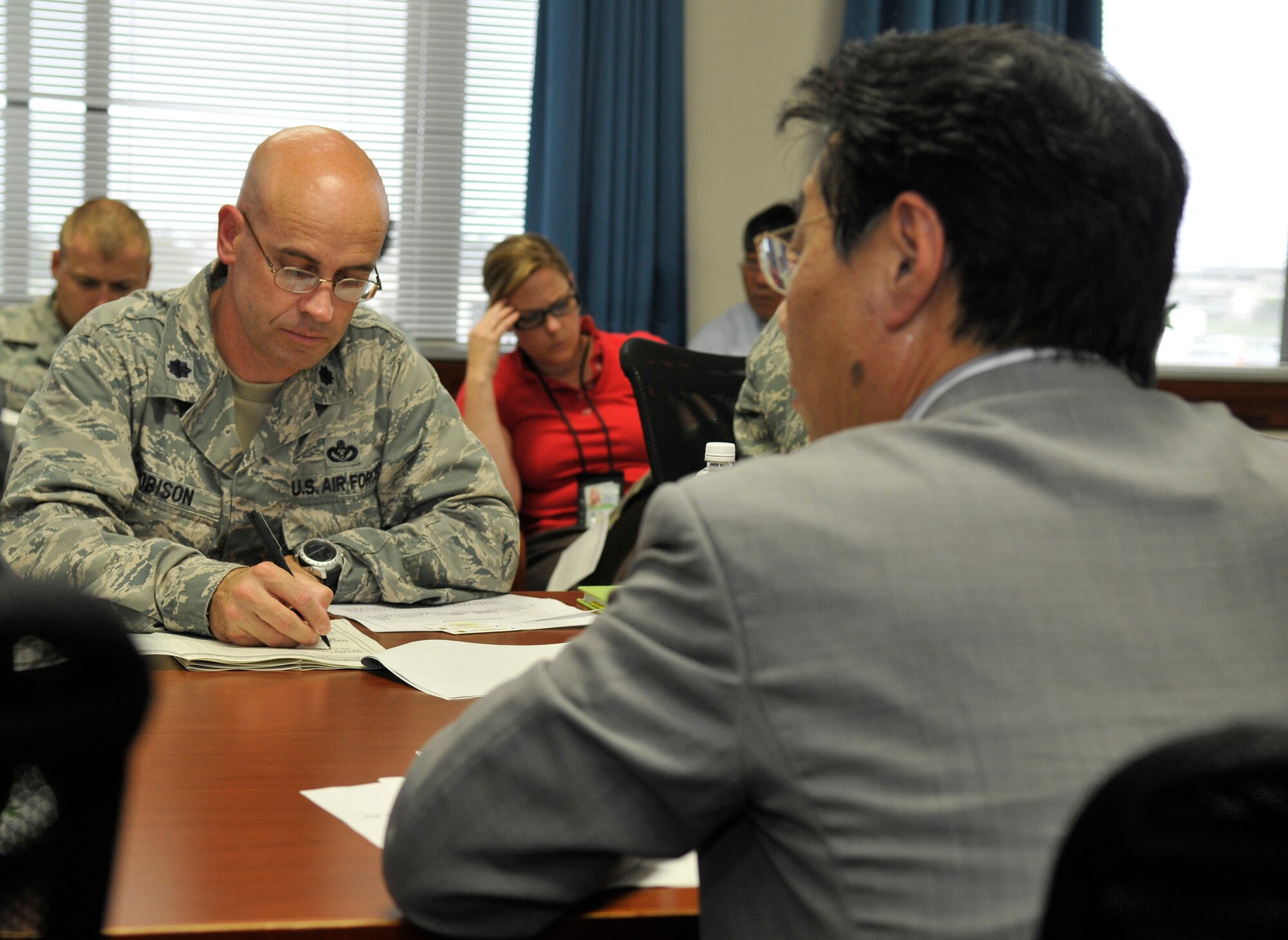 MISAWA AIR BASE, Japan -- Lt. Col. Dwayne Robison, 35th Civil Engineer Squadron commander, writes notes during a meeting with Tohoku Electric Company officials Aug. 31 in the 35 CES conference room here. Members from Tohoku Electric Company came to Misawa Air Base to praise base efforts in conserving power. (U.S. Air Force photo/Tech. Sgt. Phillip Butterfield)

