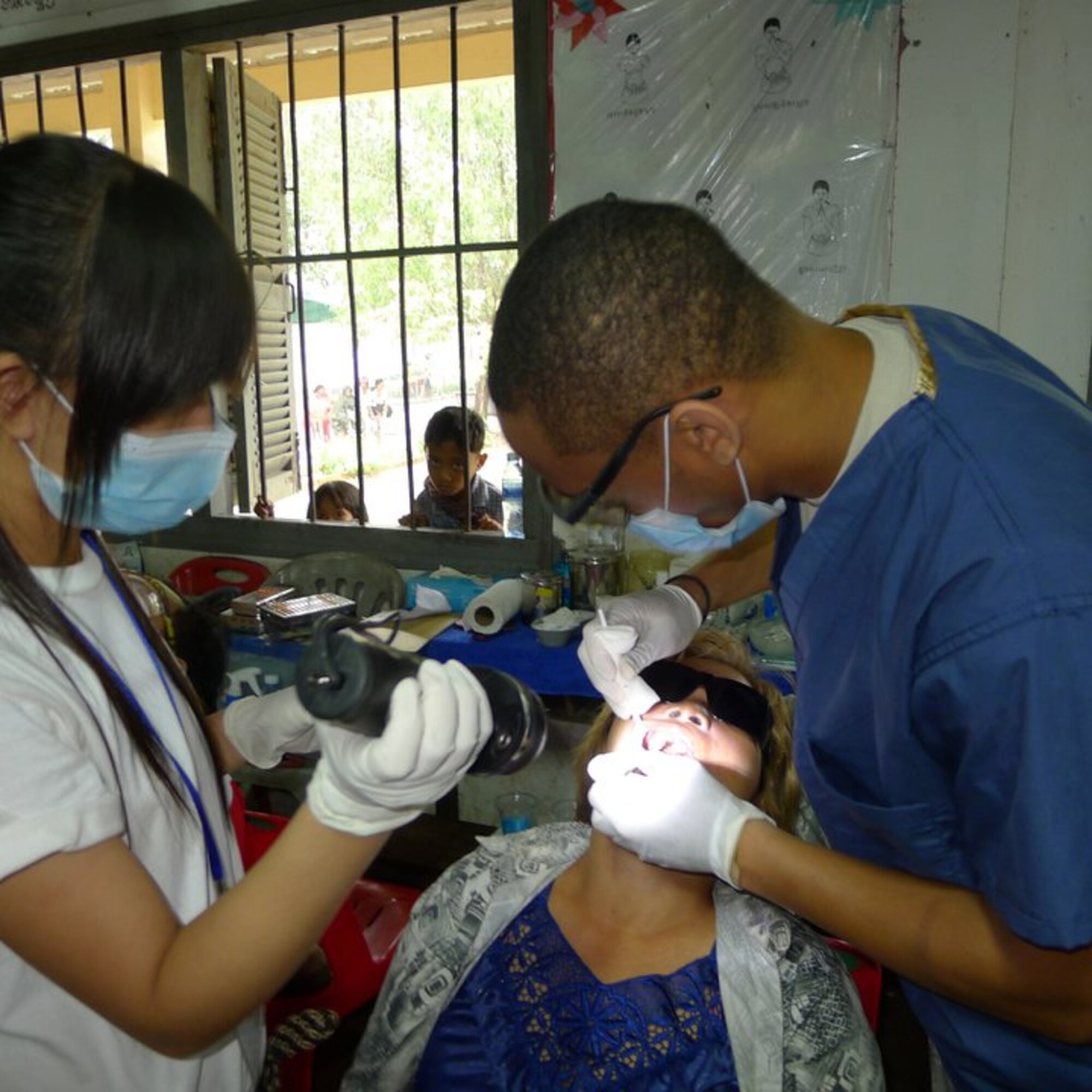 OPERATION PACIFIC ANGEL, Cambodia -- Senior Airman Kentarvius Todd, 8th Medical Operations Squadron dental technician, works with a patient during his recent deployment here in August. Todd supported Operation Pacific Angel 2011 by helping treat more than 600 dental patients at an estimated value of $110,000. (Courtesy photo)