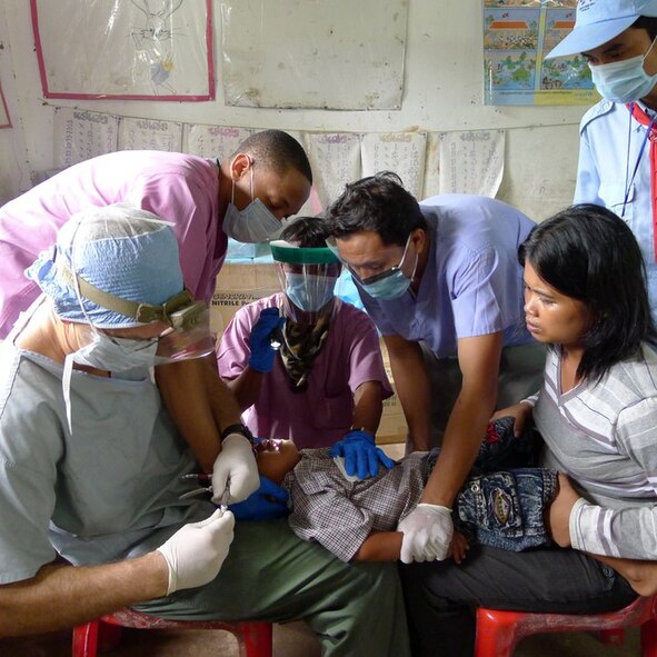 OPERATION PACIFIC ANGEL, Cambodia -- Senior Airman Kentarvius Todd, 8th Medical Operations Squadron dental technician, works with his team on a patient during his recent deployment here in August. Todd supported Operation Pacific Angel 2011 by helping treat more than 600 dental patients at an estimated value of $110,000. (Courtesy photo)