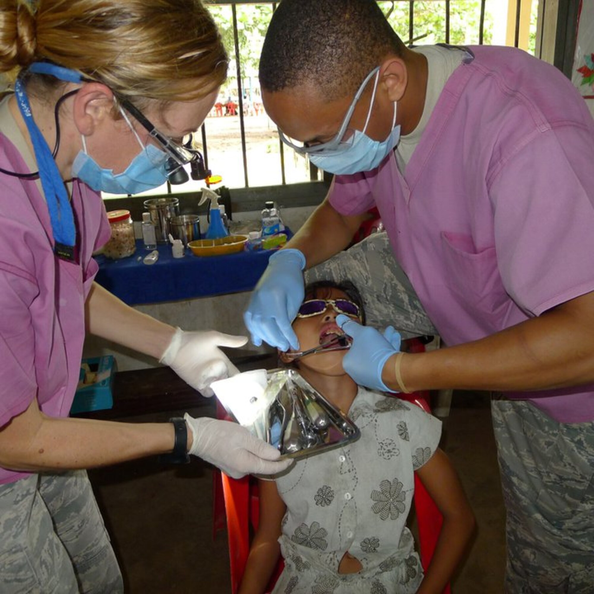 OPERATION PACIFIC ANGEL, Cambodia -- Senior Airman Kentarvius Todd, 8th Medical Operations Squadron dental technician, works with a patient during his recent deployment here in August. Todd supported Operation Pacific Angel 2011 by helping treat more than 600 dental patients at an estimated value of $110,000. (Courtesy photo)