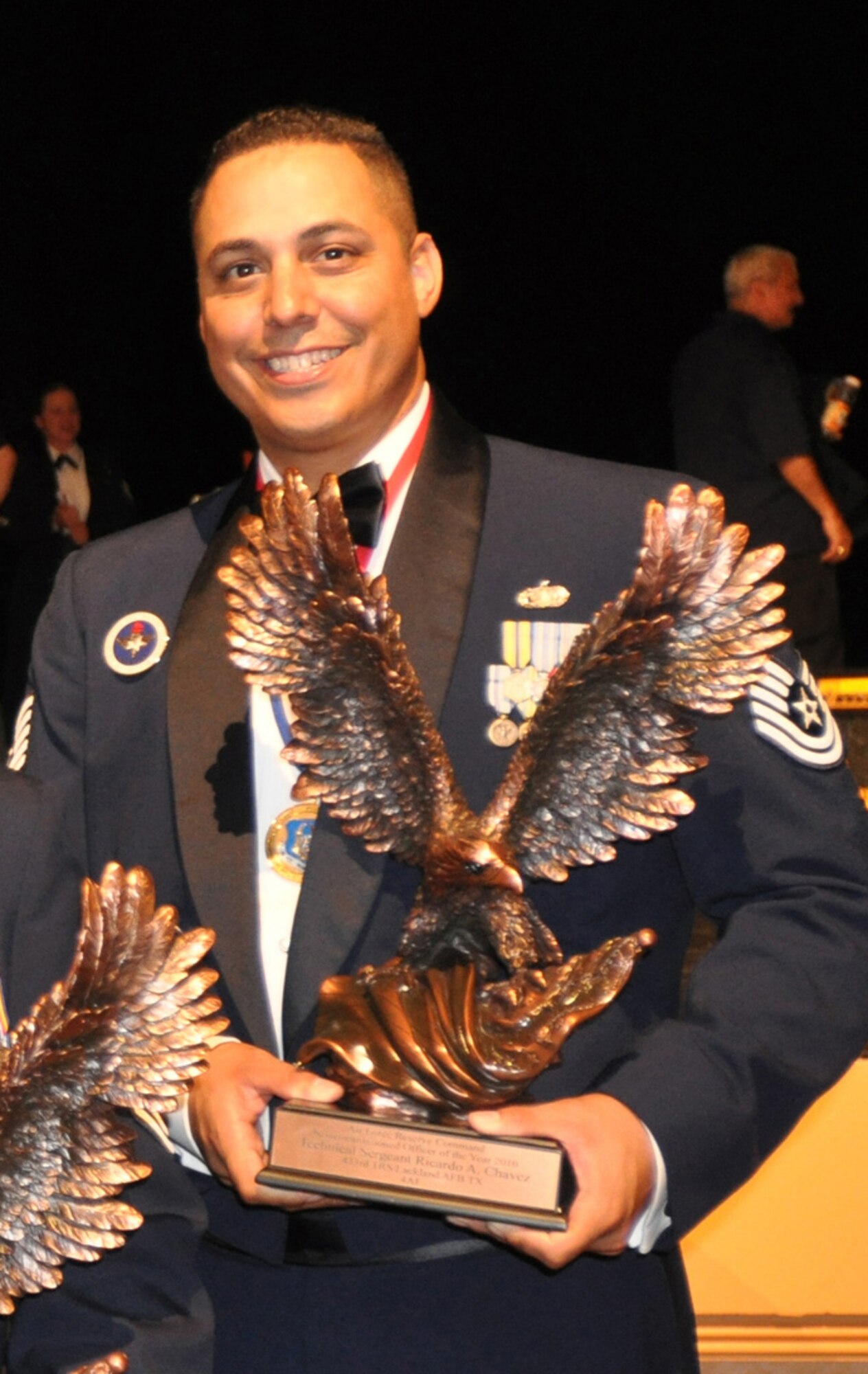 Technical Sgt. Ricardo Chavez cradles the large trophy presented to him as the Air Force Reserve Command Outstanding NCO for 2010. He subsequently was named one of the 12 Outstanding Airmen of the year for 2010 at the Air Force level. Air Force Reserve Command honored its Outstanding Airmen of 2010 during an awards banquet at Kissimmee, Fla., Aug. 16, 2011.Chavez is a master military training instructor and a reservist with the 433rd Training Squadron at Lackland Air Force Base, Texas, which now forms part of Joint Base San Antonio. Chavez serves fulltime on an Active Guard and Reserve tour of duty as the 737th Training Support Squadron unit training manager. The unit is Air Force basic military training's largest squadron with more than 150 people. Besides his MTI duties, Chavez is responsible for the overall management of the unit's training program. He conducts comprehensive trainee orientation and compliance documentation for newly assigned instructors.(U.S. Air Force photo/Philip Rhodes)
