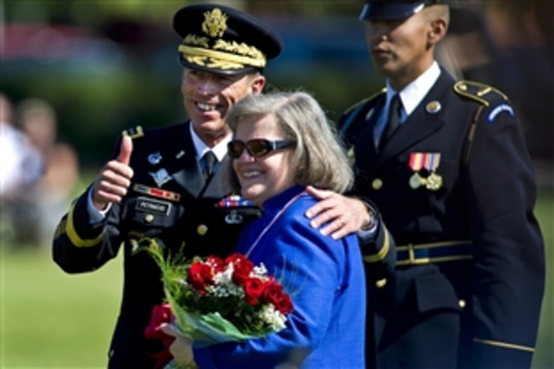 Army Gen. David H. Petraeus gives the thumbs up with his wfe, Holly, at his retirement ceremony and Armed Forces Farewell on Joint Base Meyer-Henderson Hall, Va., Aug. 31, 2011. Petraeus retired after a 37-year career to become CIA director.