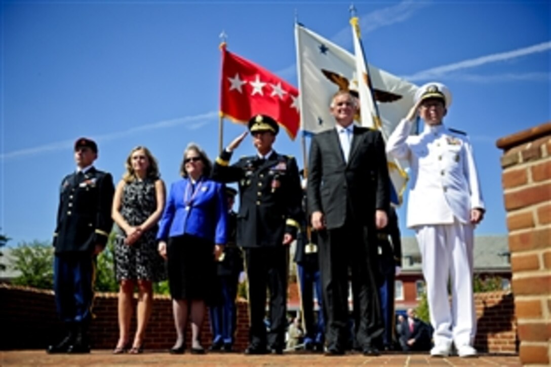 Army Gen. David H. Petraeus, center, salutes as he stands with his family, Deputy Defense Secretary William J. Lynn III and Navy Adm. Mike Mullen, chairman of the Joint Chiefs of Staff, during a pass and review of troops at his Armed Forces Farewell and retirement ceremony, Joint Base Myer-Henderson Hall, Va., Aug. 31, 2011.
