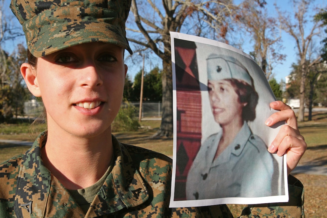 Lance Cpl. Richelle D. Kline, an administration specialist for Headquarters Battalion, 2nd Marine Division, holds a picture of her mother in her Marine Corps service uniform, aboard Marine Corps Base Camp Lejeune, N.C., Dec. 1. Kline is a third generation Marine and hopes that when she has children that they follow in the family tradition.
