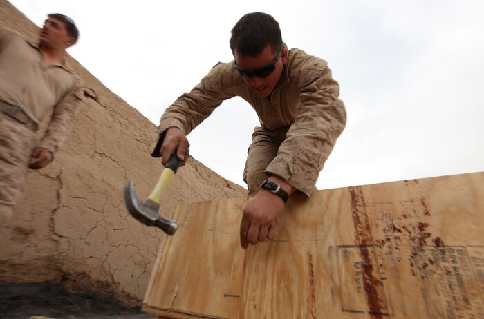 Lance Cpl. Bonstihl Bourne, of South Boardman, Mich., completes work on a set of shelves at Patrol Base New Jersey, Afghanistan, Nov. 24. Bourne is a combat engineer with Combat Logistics Company 6, 2nd Marine Logistics Group (Forward). The CLC, which is comprised of two engineer platoons and one motor transportation platoon, is an element of Combat Logistics Battalion 6 and was formed to provide direct support to 1st Battalion, 6th Marine Regiment, during Operation Eastern Storm. Engineers were tasked with building several of the patrol bases along Route 611. Once force protection measures were in place, such berms and concertina wire, the Marines then built comfort items that included benches, hygiene facilities and gym equipment for the infantrymen operating from the bases. (U.S. Marine Corps photo by Sgt. Justin J. Shemanski)