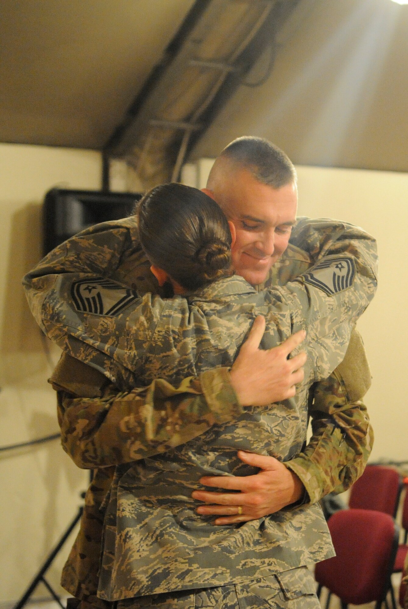 Senior Master Sgts. Don Gurganus and Jen Segerson embrace after renewing their vows at the Transit Center at Manas, Kyrgyzstan, Nov. 30, 2011. Gurganus and Segerson both passed through the Transit Center on their way to Afghanistan.  Gurganus will be the American Forces Network superintendent at the New Kabul Compound and Segerson will be the Bagram Airfield communications superintendent. The couple is deployed from Ramstein Air Base, Germany. (U.S. Air Force photo/Tech. Sgt. Tammie Moore)